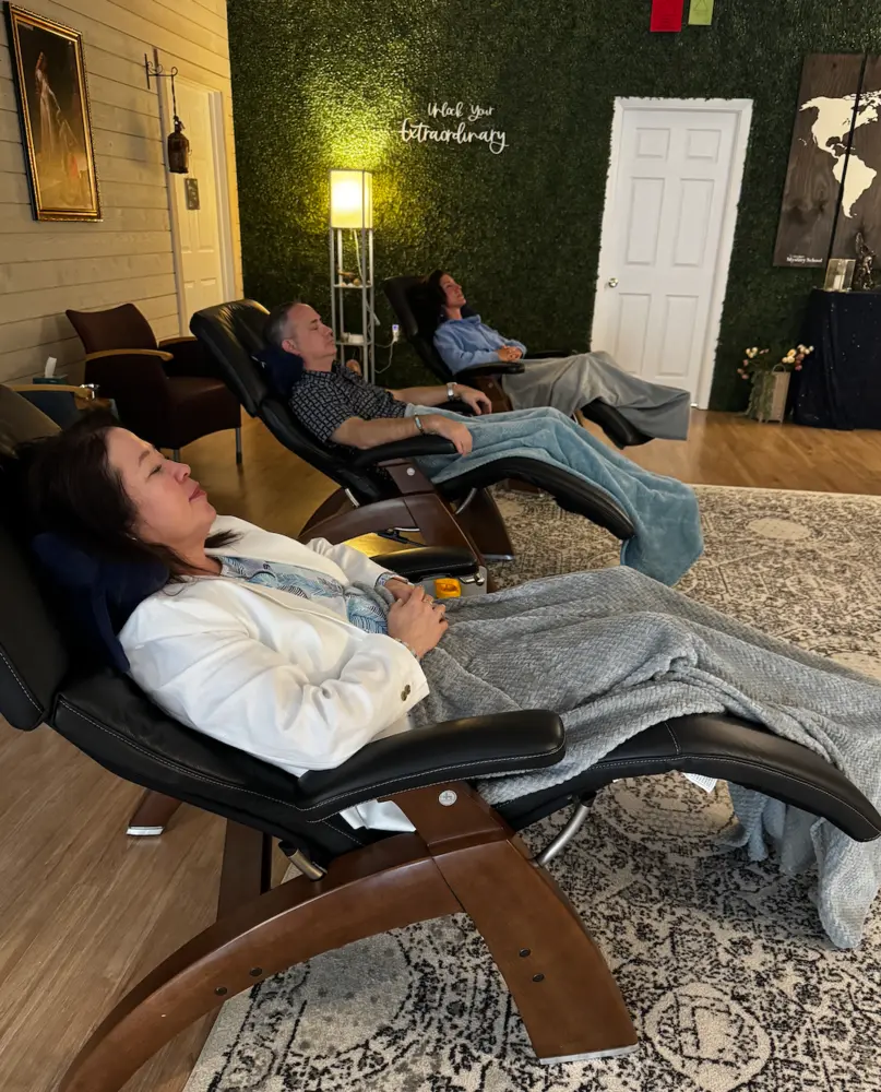 Participants relaxing in zero-gravity chairs during an astral travel class at The Center at Keystone in Wyomissing, PA
